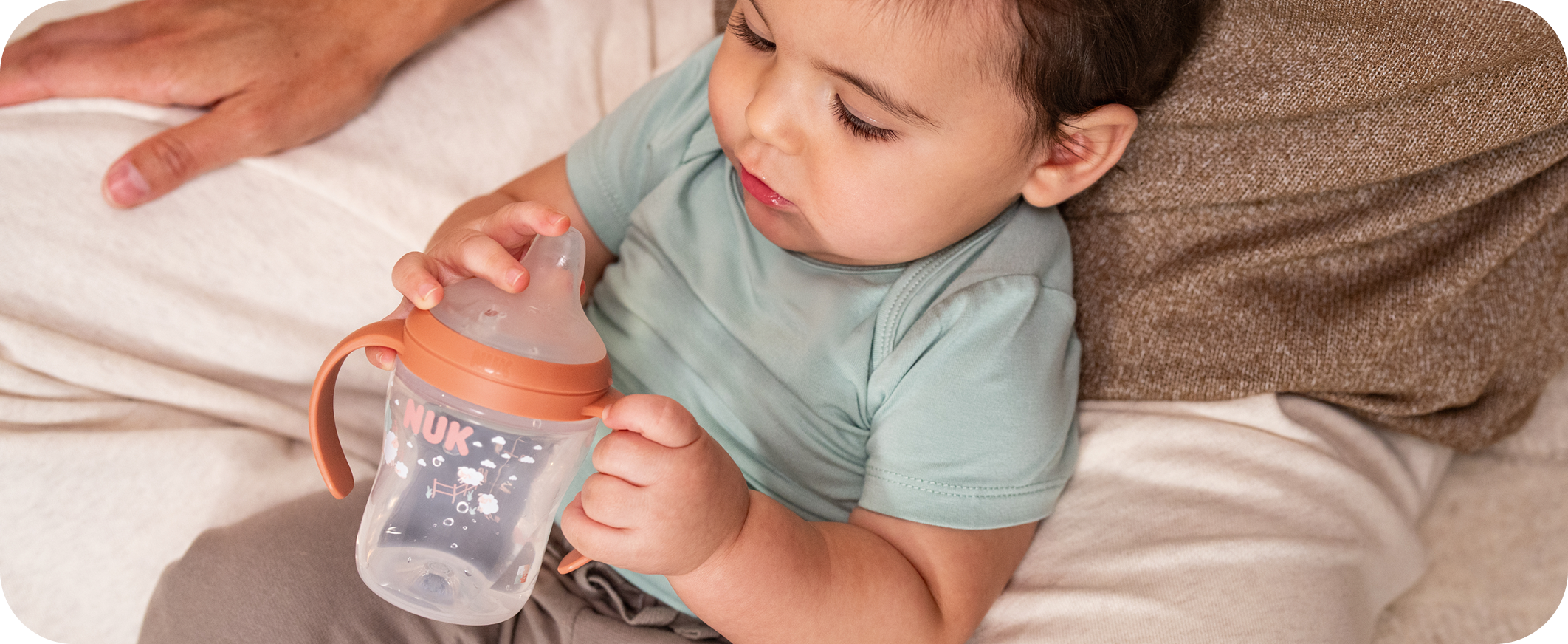 Baby with NUK sippy cup